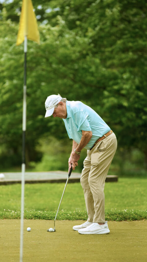 Foulkeways Resident at chip and putt green