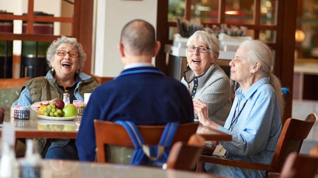 Foulkeways Residents dining and laughing