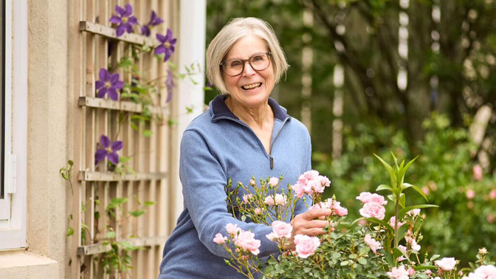 Foulkeways Resident with rose bush