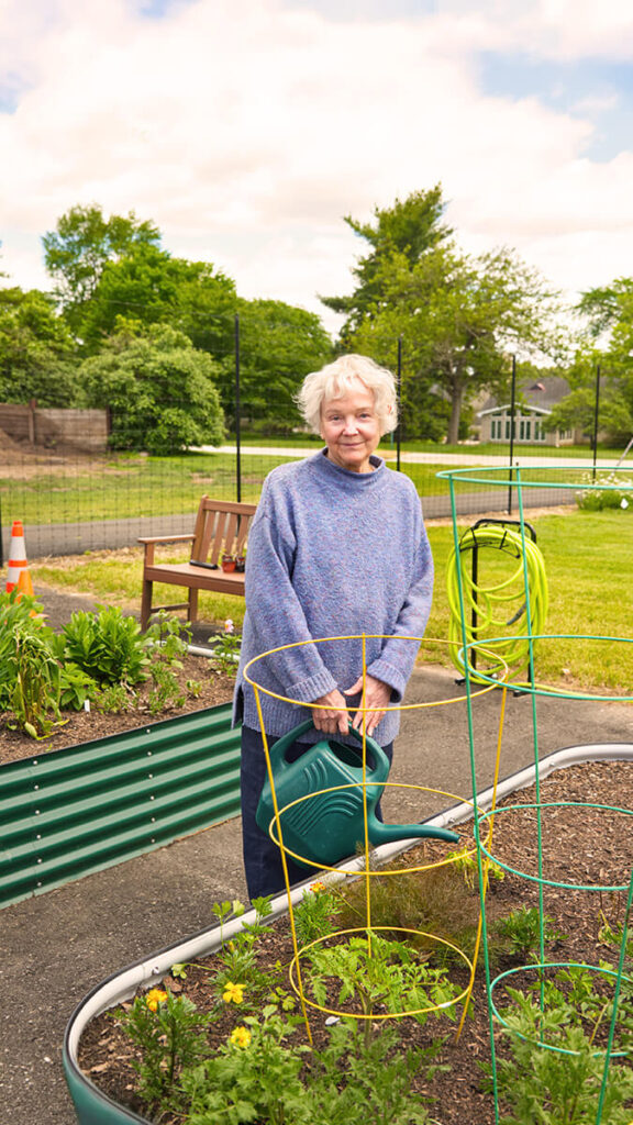 Foulkeways Resident watering in community garden